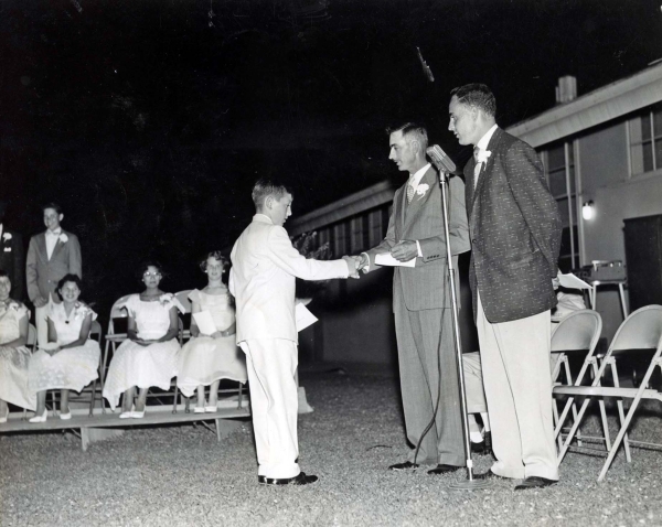 Clarence Borba Sr. and Principal Mr. Roveto award Clarence Jr. his grammar school diploma in 1955.